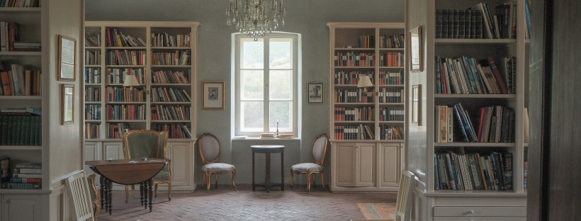 A room with built-in shelves and light blue paint.
